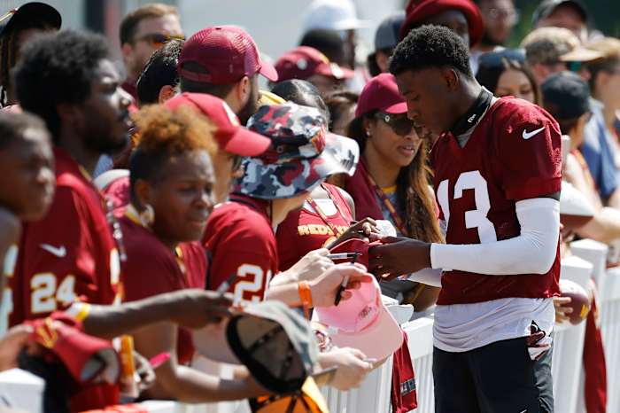 Emmanuel Forbes signs an autograph for Commanders fans